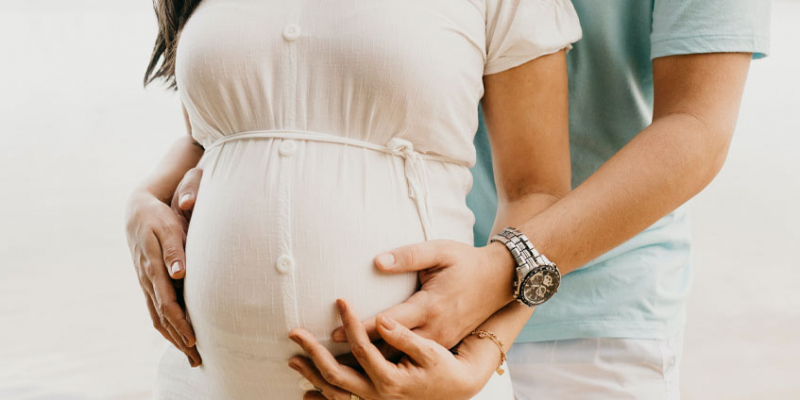 Pregnant woman with man holding hands