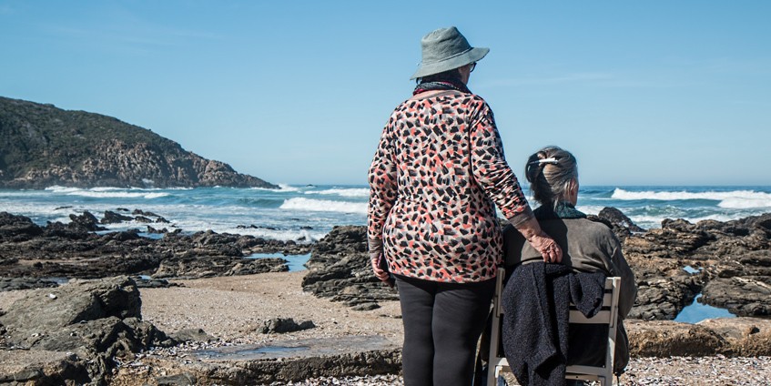 Elderly couple looking at the ocean