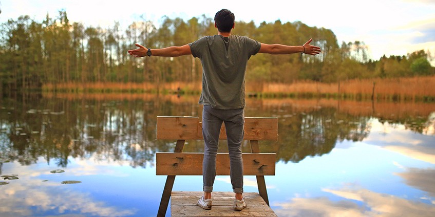 Man facing pond