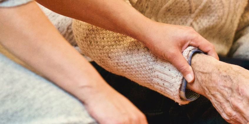 Woman's hand on older male hand
