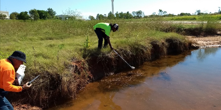 Collecting mosquito larvae by the river.