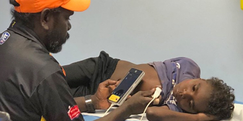 Man using phone to monitor boys heart