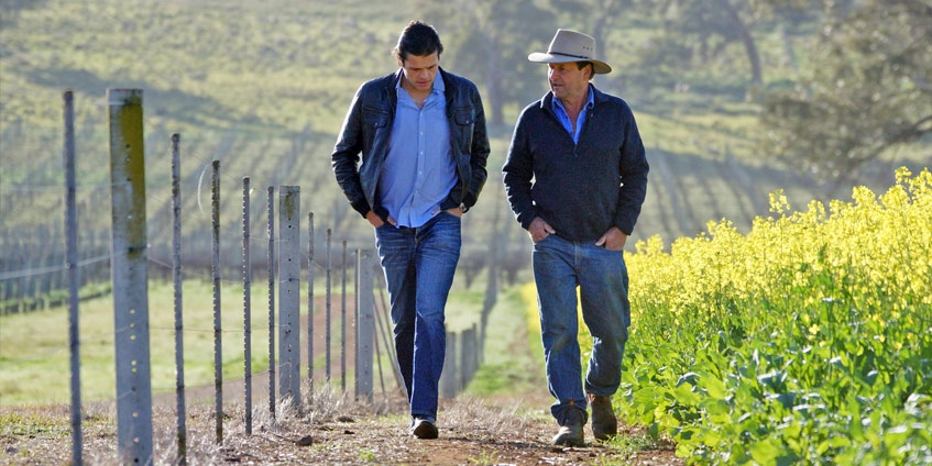 Two men walking on a farm