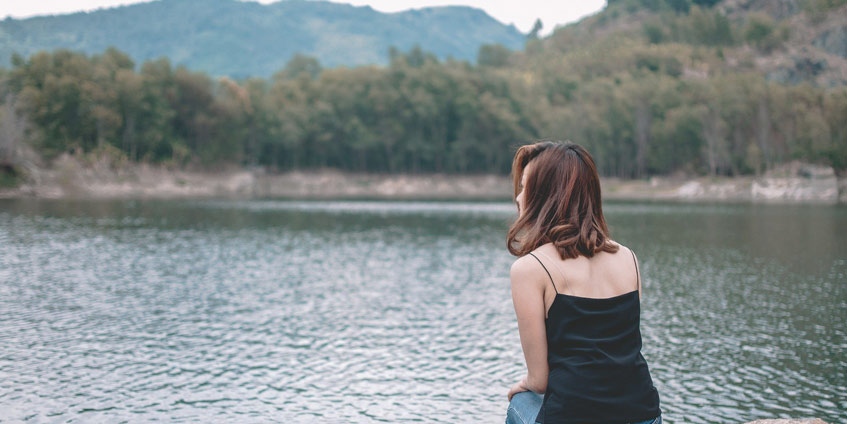 Young woman by the lake