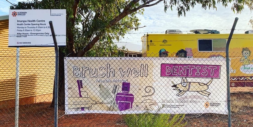 Brush well banner in front of dental truck