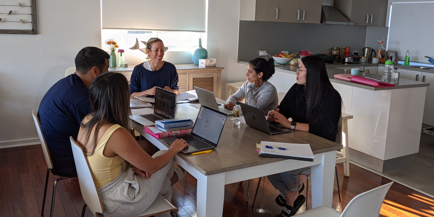 Group of people and students at dining table
