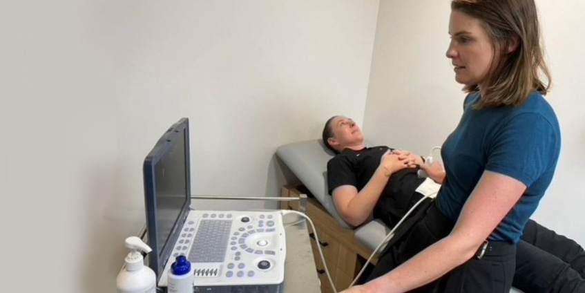 Dr Melanie Johnson using a standard ultrasound machine.