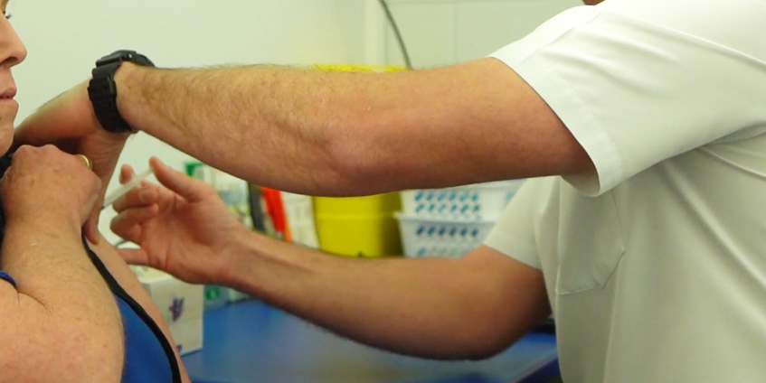 Vaccination being performed on woman's arm