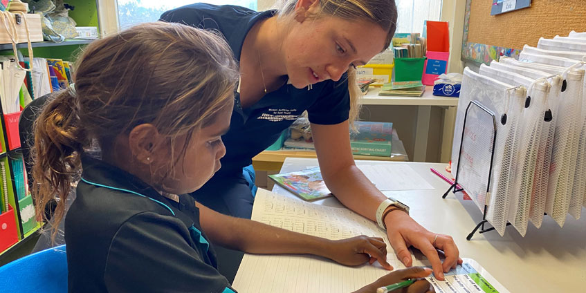 Yalgoo Primary School student Angelica Simms with occupational therapy student Keely Fitzpatrick.