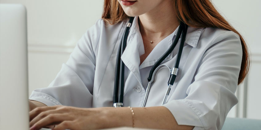 Female doctor using laptop