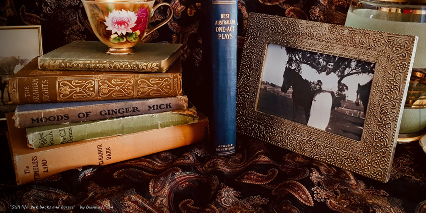 Old framed photograph of a woman surrounded by books