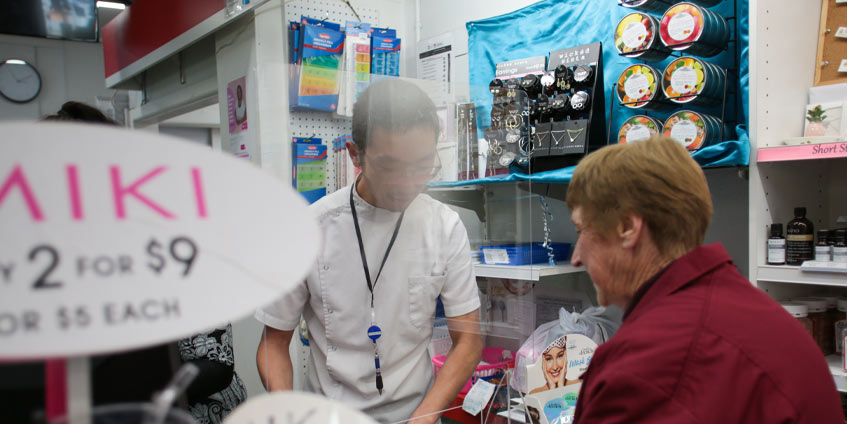 Pharmacist talking to customer