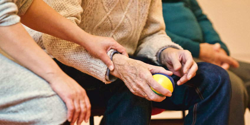 Woman holding mature mans hand