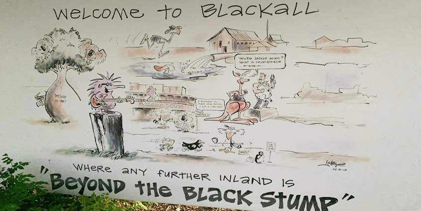 Local Blackall welcome to Blackall illustrated cartoon sign - where any further inland is beyond the black stump