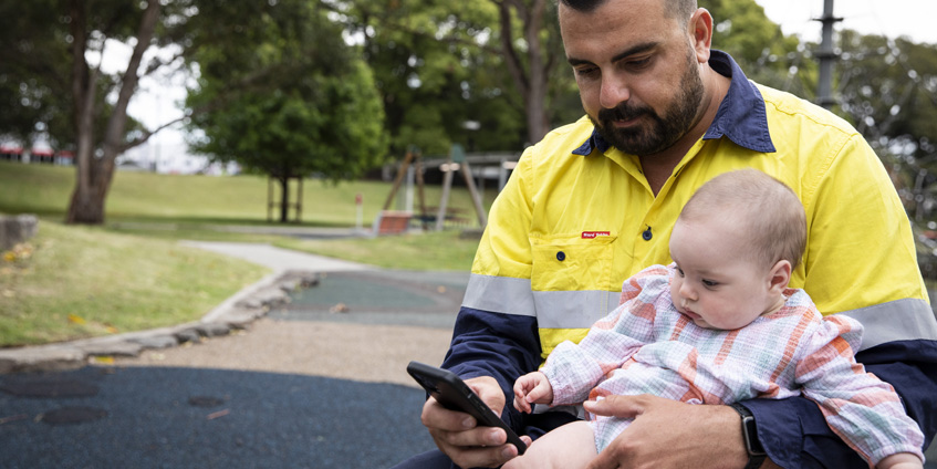 Father and baby using mobile phone