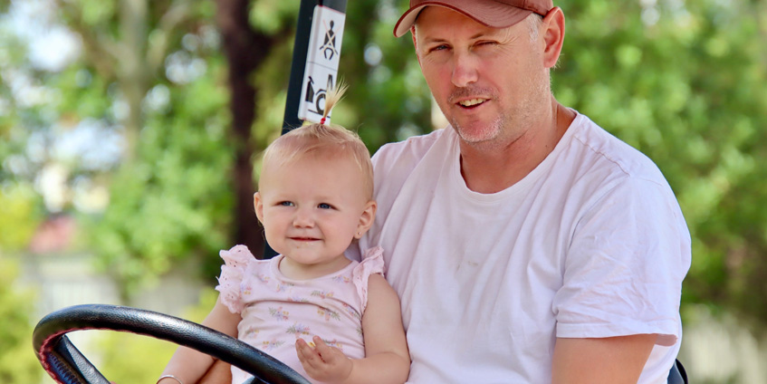 Father and baby daughter on a tractor