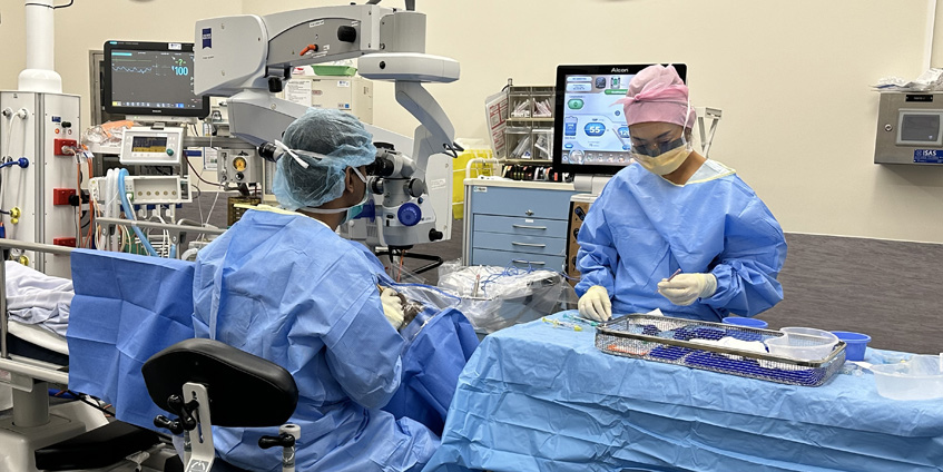 An ophthalmologist and a theatre nurse perform cataract surgery on a patient at Katherine Hospital, NT