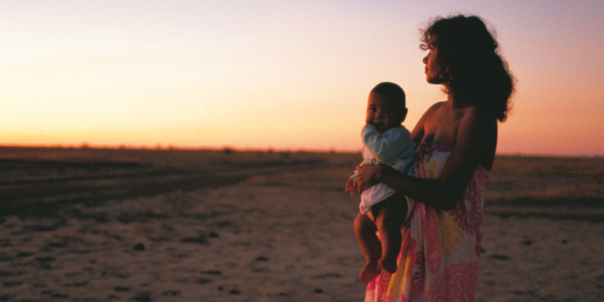 Mother with baby at sunset