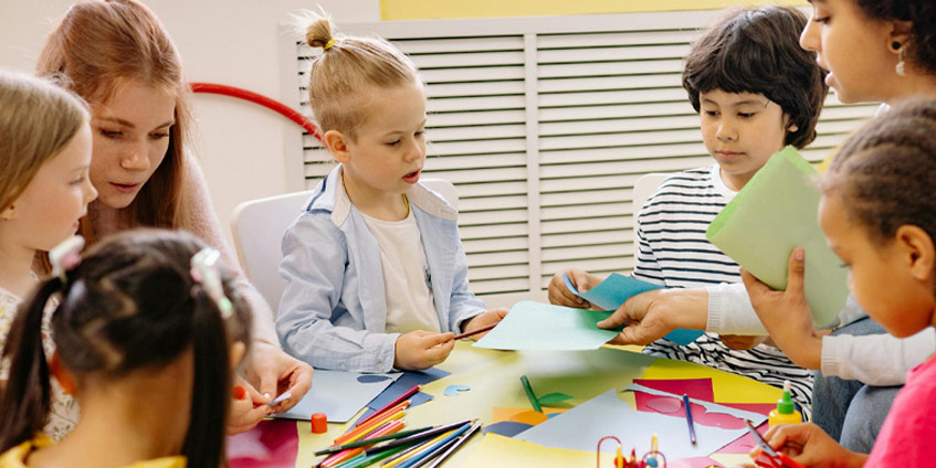 Young children and teacher at a table