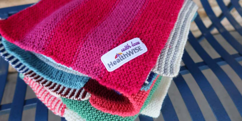 Bright folded Health Wise labelled blankets