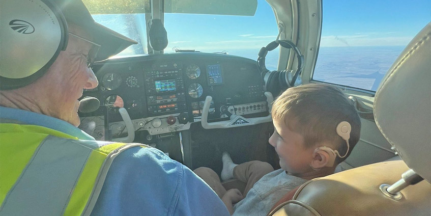 Nate with Pilot Owen Crees in the cockpit on a flight
