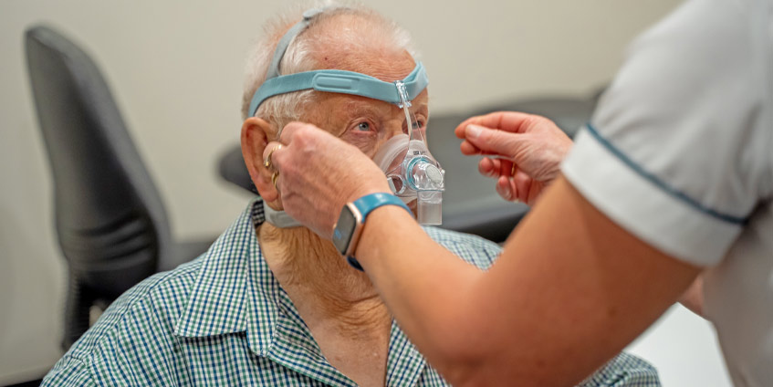 Pharmacist Karen fitting a sleep apnea mask