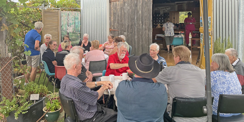 Lockington Cuppa Connections held in 2024 -group of people seated outside of garage doors