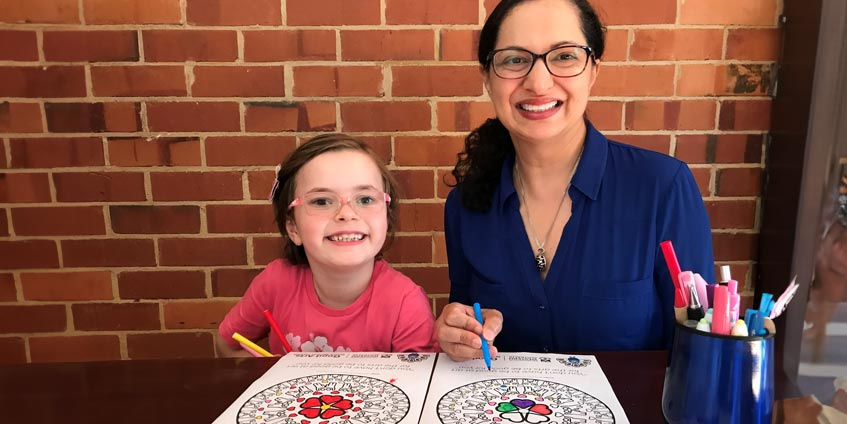 Dr Christina Davies engaging in the arts with a child.