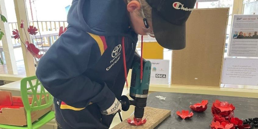 Preparing Metalwork Poppies for community soldiers memorial 