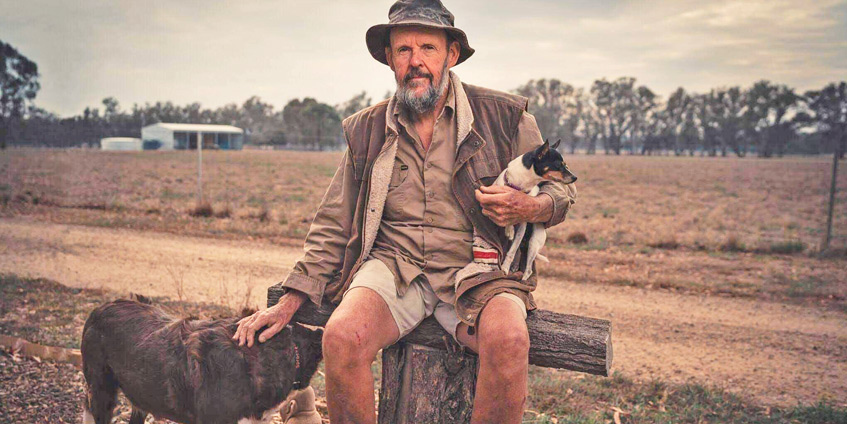 James Barclay with his dogs and rural property behind him