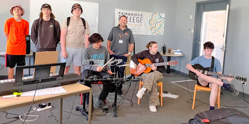 Group of high school students playing music with Lindsay Ginn