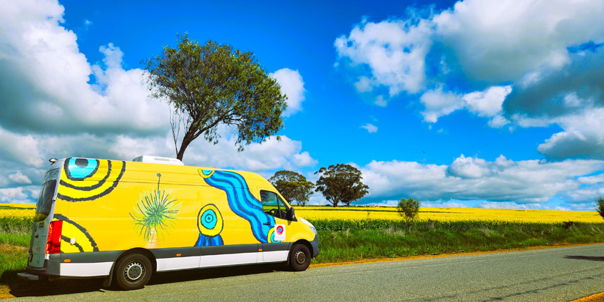 Yellow Earbus on a yellow flower stretch of road