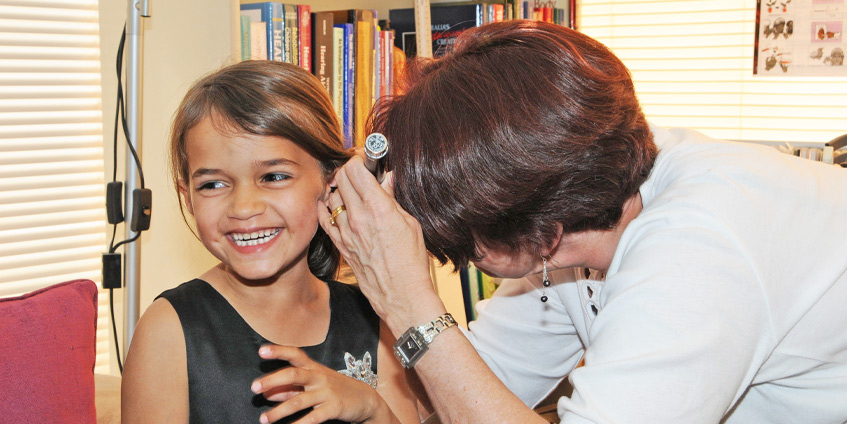 Young girl receiving a hearing check