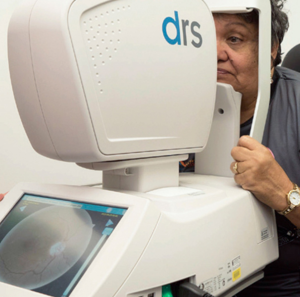 Woman having her eye scanned by machine