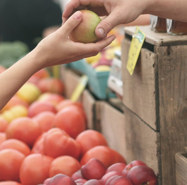 Two hands holding an apple