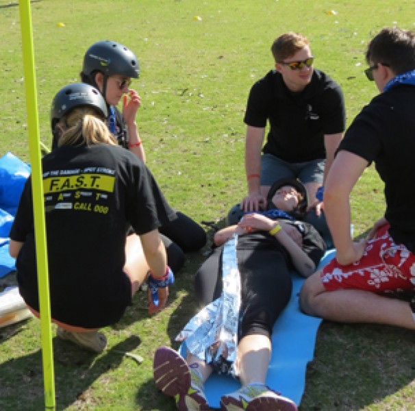 People attending to a person on a stretcher bed