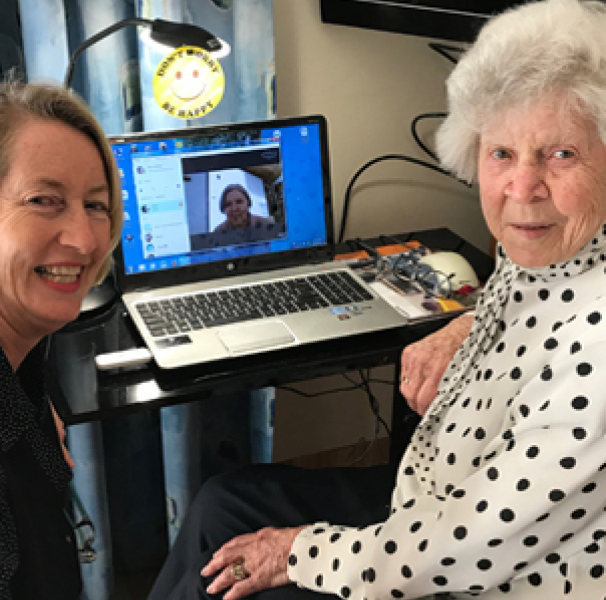 younger and older women in front of computer