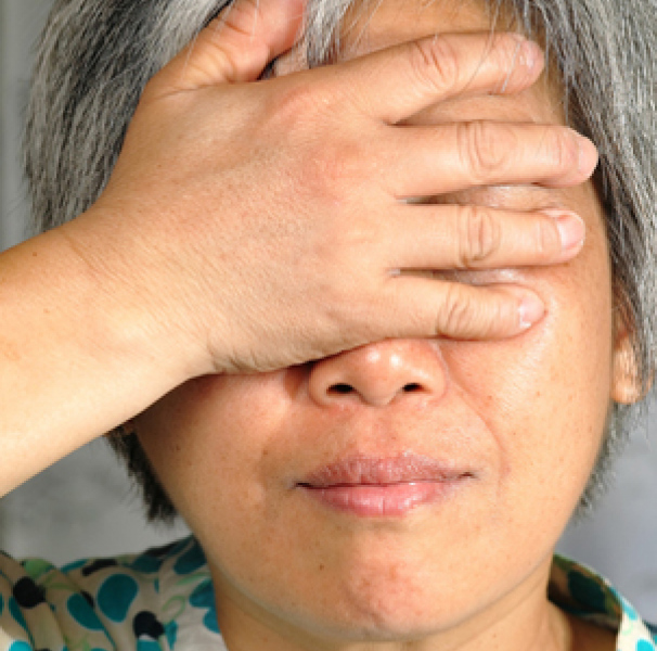 Woman holding her face
