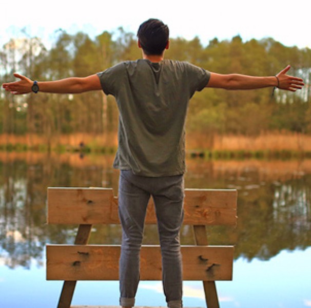 Man facing pond