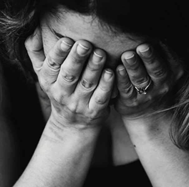Woman holding hands to face