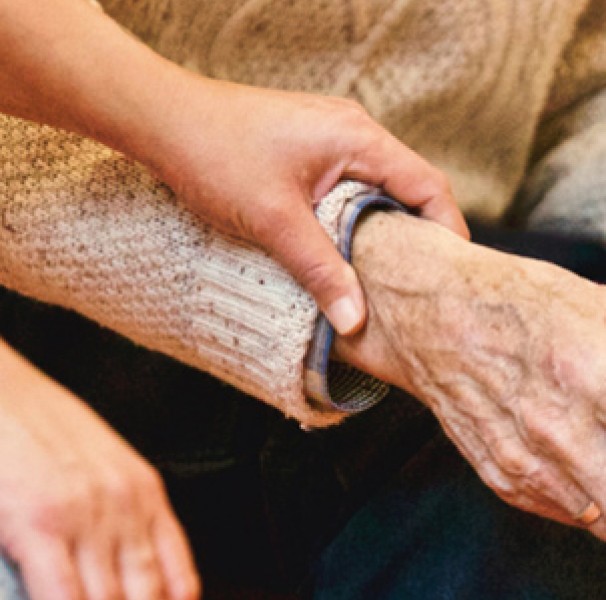 Woman's hand on older male hand