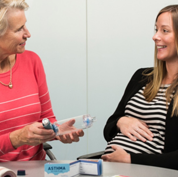 Two women with inhaler device