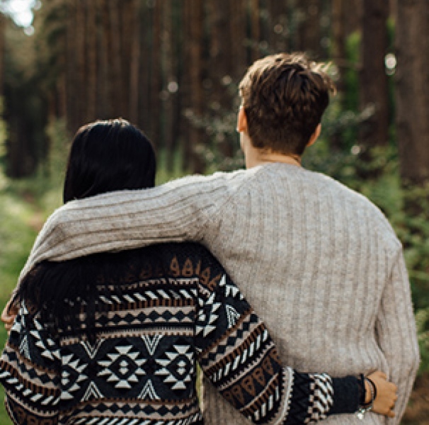 Back of young couple hugging