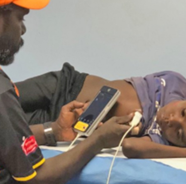 Man using phone to monitor boys heart