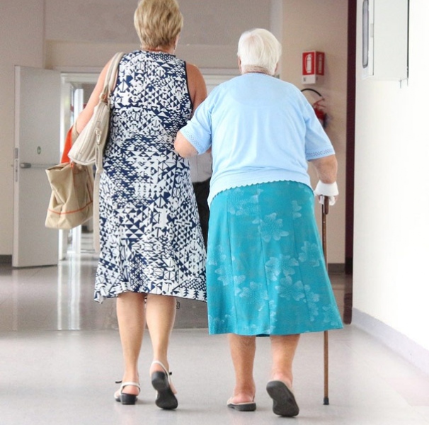 Elderly woman with younger woman in medical facility