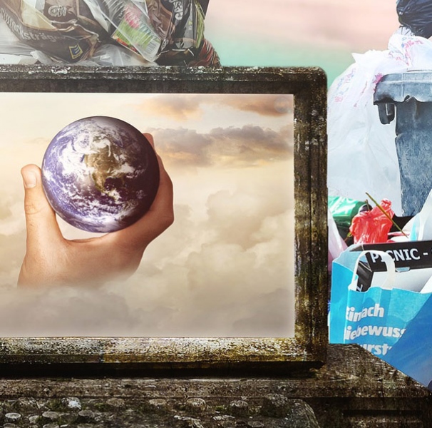 Earth on garbage laptop surrounded by waste