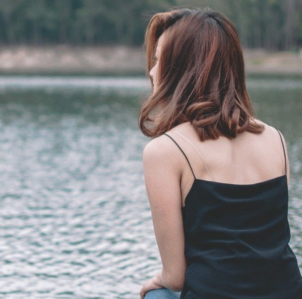 Young woman by the lake