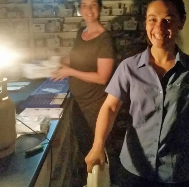 Pharmacy staff working during the bushfire and being creative with heating the iron to seal the medicine pack.