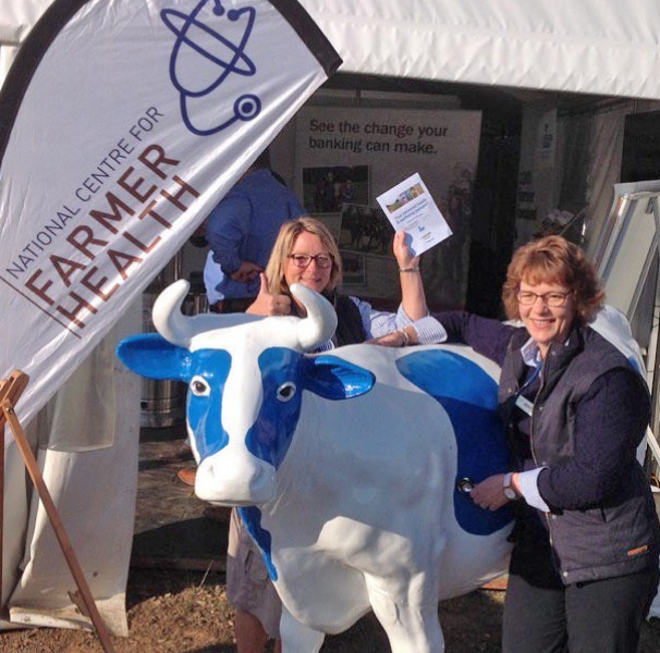 National Centre for Farmer Health RNs Jeanne van De Geest Dekker and Carolyn Alkemade showcasing a health passport at a rural field day.