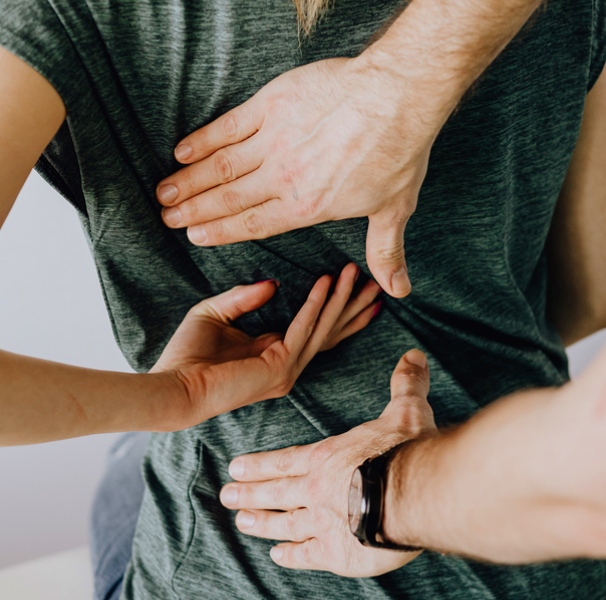 Woman with hands on her back